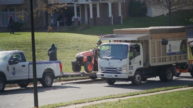 J&J Landscape Management truck at customer's property.